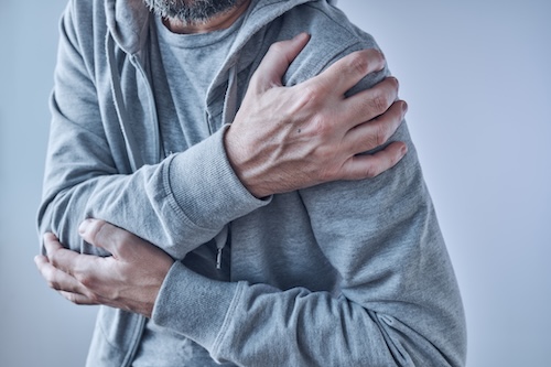 Shoulder joint pain, man with severe ache as symptom of osteoarthritis